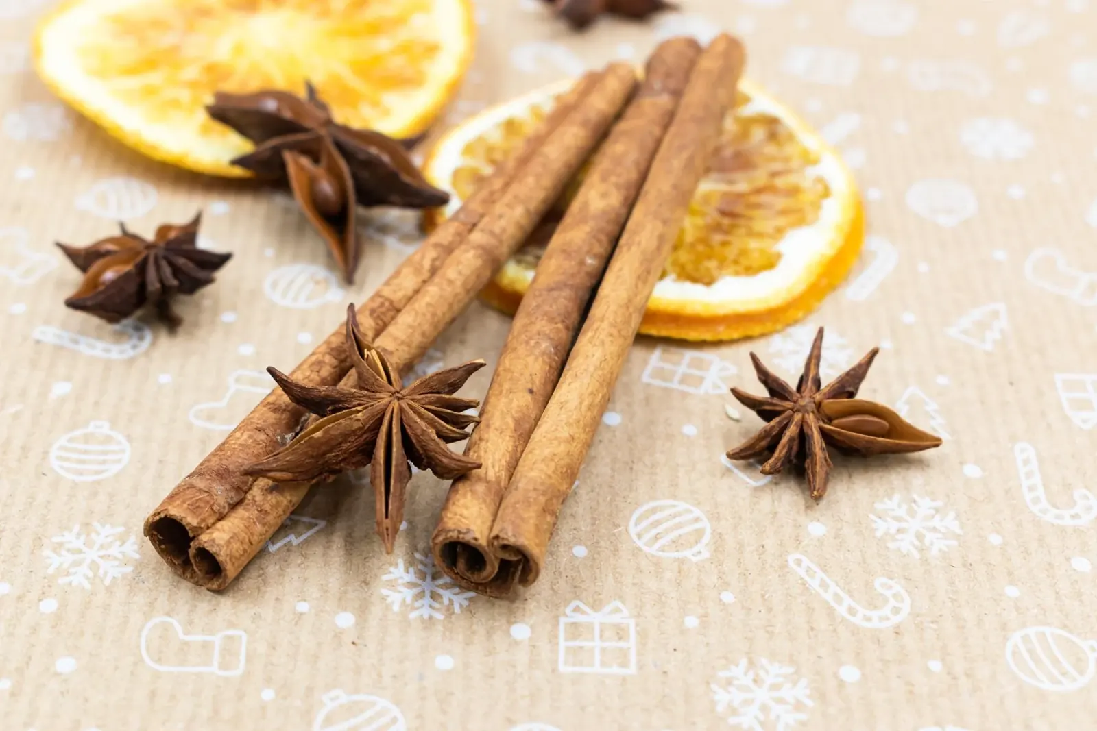 Cinnamon sticks, star anise and whole spices arranged on a board