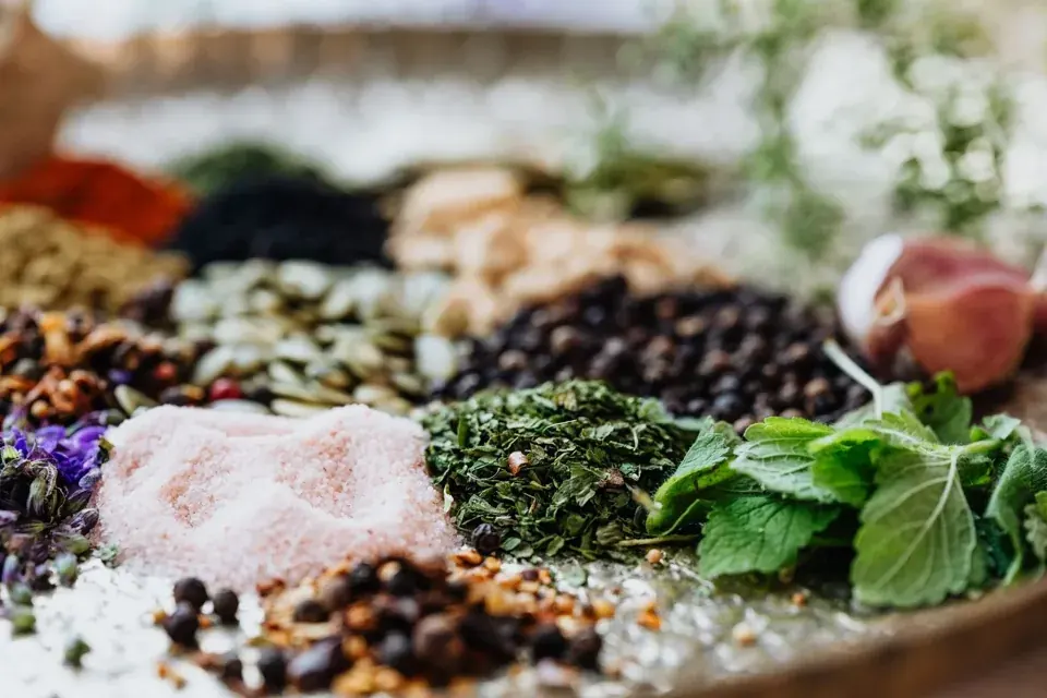 Whole spices arranged with herbs